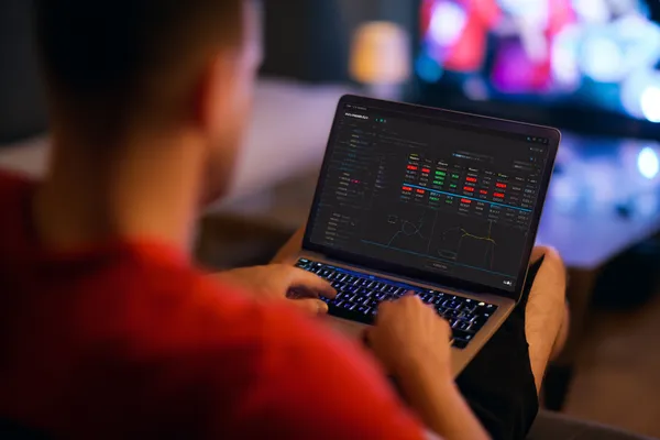 A close-up shot of golden coins falling around a spinning roulette wheel, representing immersive casino action at BINGOMAX.
